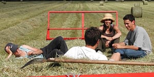 teenage farmers sitting in the field