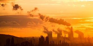 Smoke stacks during sunset