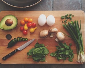 Cutting board with vegetables and a knife