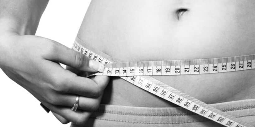 nutrition in crisis_measure tape stomach_bannersnack woman with measure tape around stomach